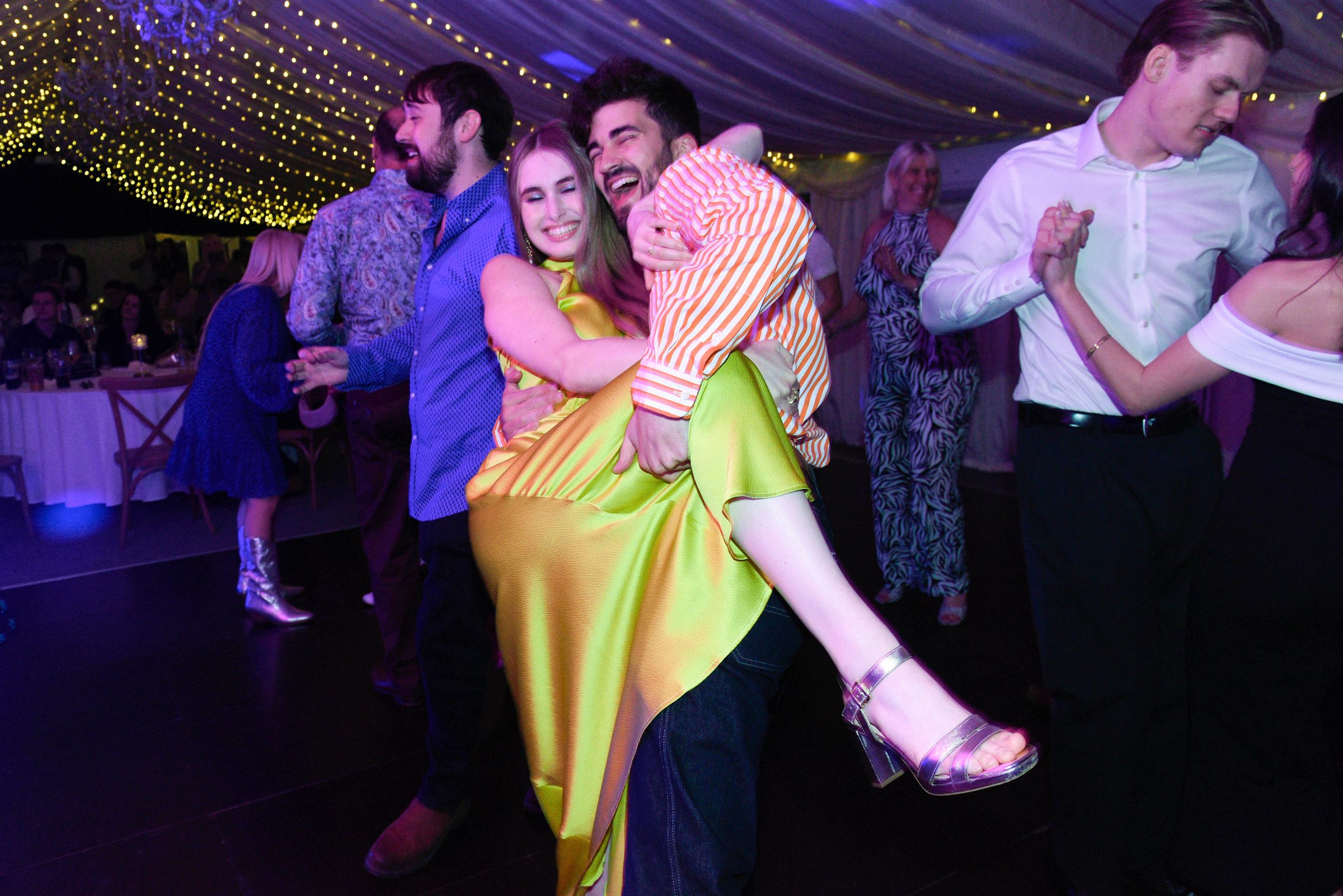 Callum carrying Celina on the dance floor